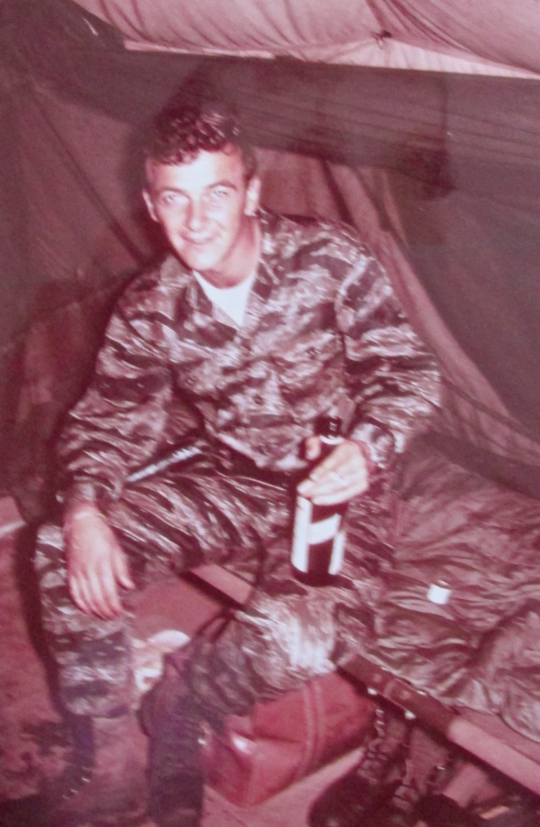 Sgt. Sanderson at 20 with a bottle of Scotch shortly after returning from a five-day patrol with this team looking for North Vietnam Army or Vietcong activity in the bush. Photo provided 