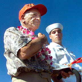 CTY WEST LOCH -Ship's cook second class Roy Sannella crossed his chest just prior to throwing in two long stemmed roses during the 60th Commemoration Ceremony of the West Loch Disaster held in Pearl Harbor yesterday. Honolulou Star-Bulletin Photo by Cindy Ellen Russell, 05-21-04