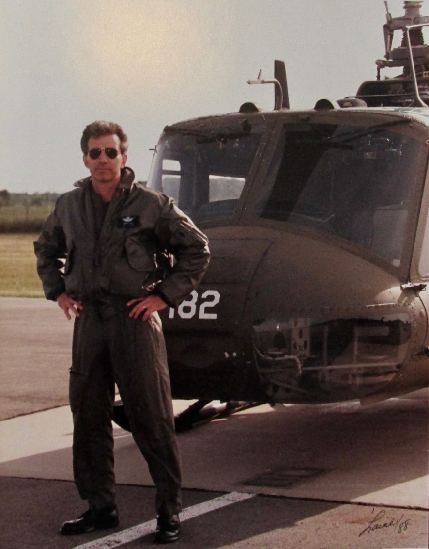 Laney is standing in front of his Huey helicopter he flew in Grand Ledge, Michigan with the Army National Guard. He was roughly 35 at the time. Photo provided