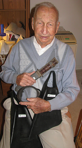 Lumsden holds the flippers, mask and knife he used during the invasions of Iwo Jima, Okinawa and Borneo when he served as a "Frogman" in World War II.